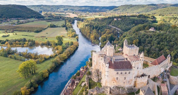 photo of aerial view of Château de Beynac and beynac et cazenac town, France.