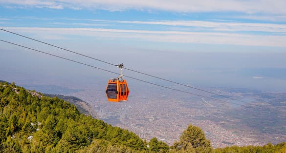 photo of two ropeway cabs are going up in Denizli in Turkey.