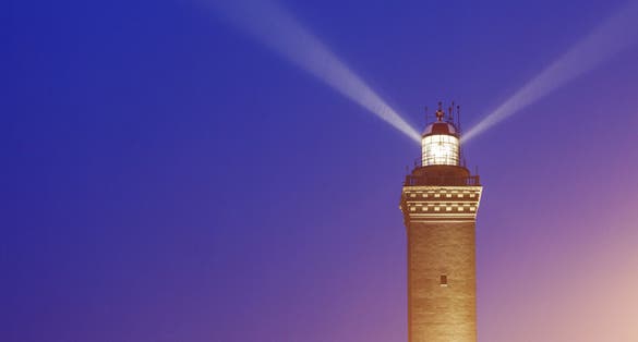 photo of Lighthouse of Genoa at sunset. Genoa, Liguria, Italy,