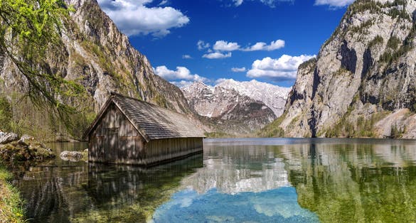 Photo of famous boat house hut with view on Obersee lake in front of Watzmann alpine mountain in the Berchtesgadener land bavaria national park ,German .