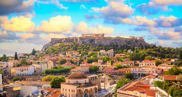 Photo of skyline of Athens with Monastiraki square and Acropolis hill during sunset.