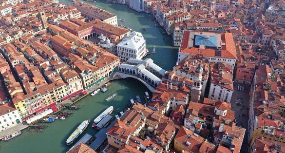 photo of Aerial drone photo of iconic and unique ponte rialto or rialto bridge crossing grand canal, Venice, Italy.