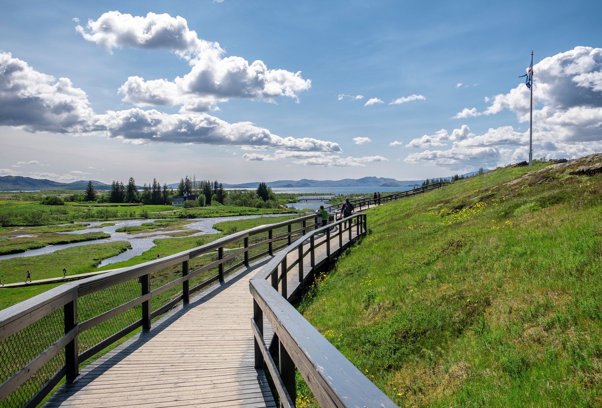 photo of Thingvellir National Park in Iceland - View of the Lögberg area with volcanic rock formations. Path to Logberg (Law Rock) mountain. Iceland, Europe.