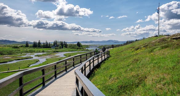 photo of Thingvellir National Park in Iceland - View of the Lögberg area with volcanic rock formations. Path to Logberg (Law Rock) mountain. Iceland, Europe.