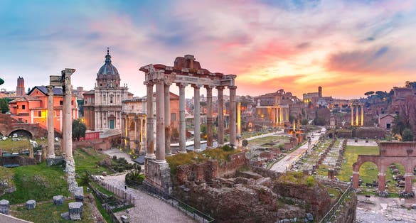 photo of panoramic view of ancient ruins of a roman forum or foro romano at sunrise in rome, Italy. view from capitoline hill.