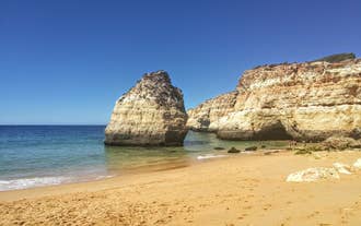 Photo of aerial view of touristic Portimao with wide sandy Rocha beach, Algarve, Portugal.