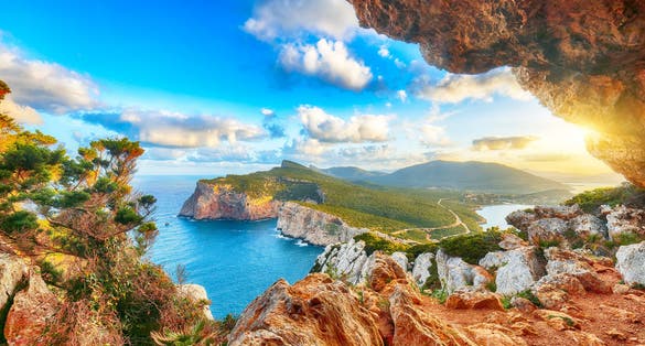 Fantastic morning view on Cacccia cape. View from the cave on the cliff, Alghero, Province of Sassari, Italy, Europe.