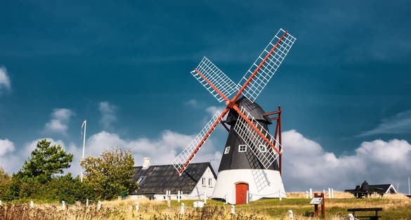 photo of view of Dutch wind mill on the island Mandoe in the wadden sea, Esbjerg, Denmark.
