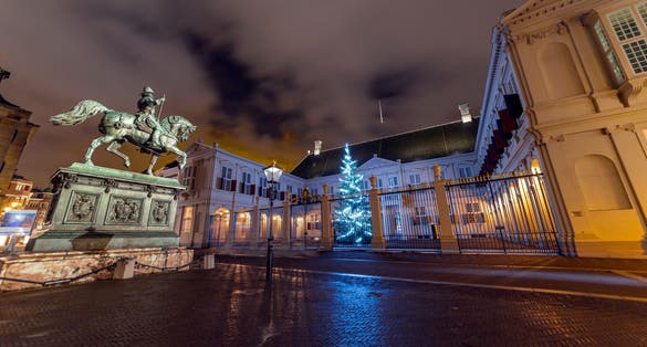 photo of Noordeinde Palace with Christmas tree at night in The Hague, The Netherlands.