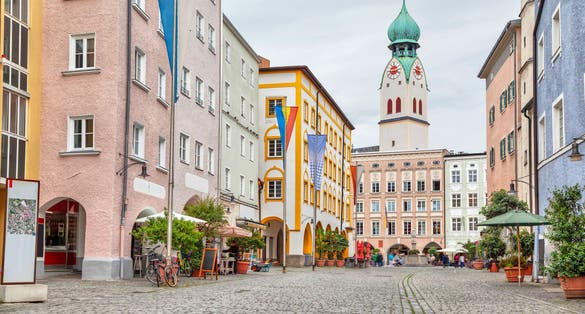 Colorful buildings in the center of Rosenheim and tower of Sankt Nikolaus Church, Germany