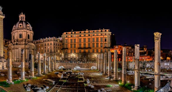 Trajan's Forum at Night in Piazza Venezia with Church of the Holy Name and Trajan Column in Rome, Italy