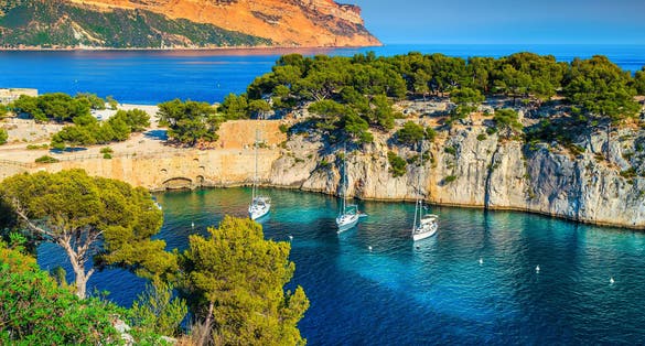 Photo of Fantastic vacation place, stunning viewpoint on the cliffs, Calanques de Port Pin bay with yachts and sailing boats, Calanques National Park near Cassis, Provence, South France, Europe.