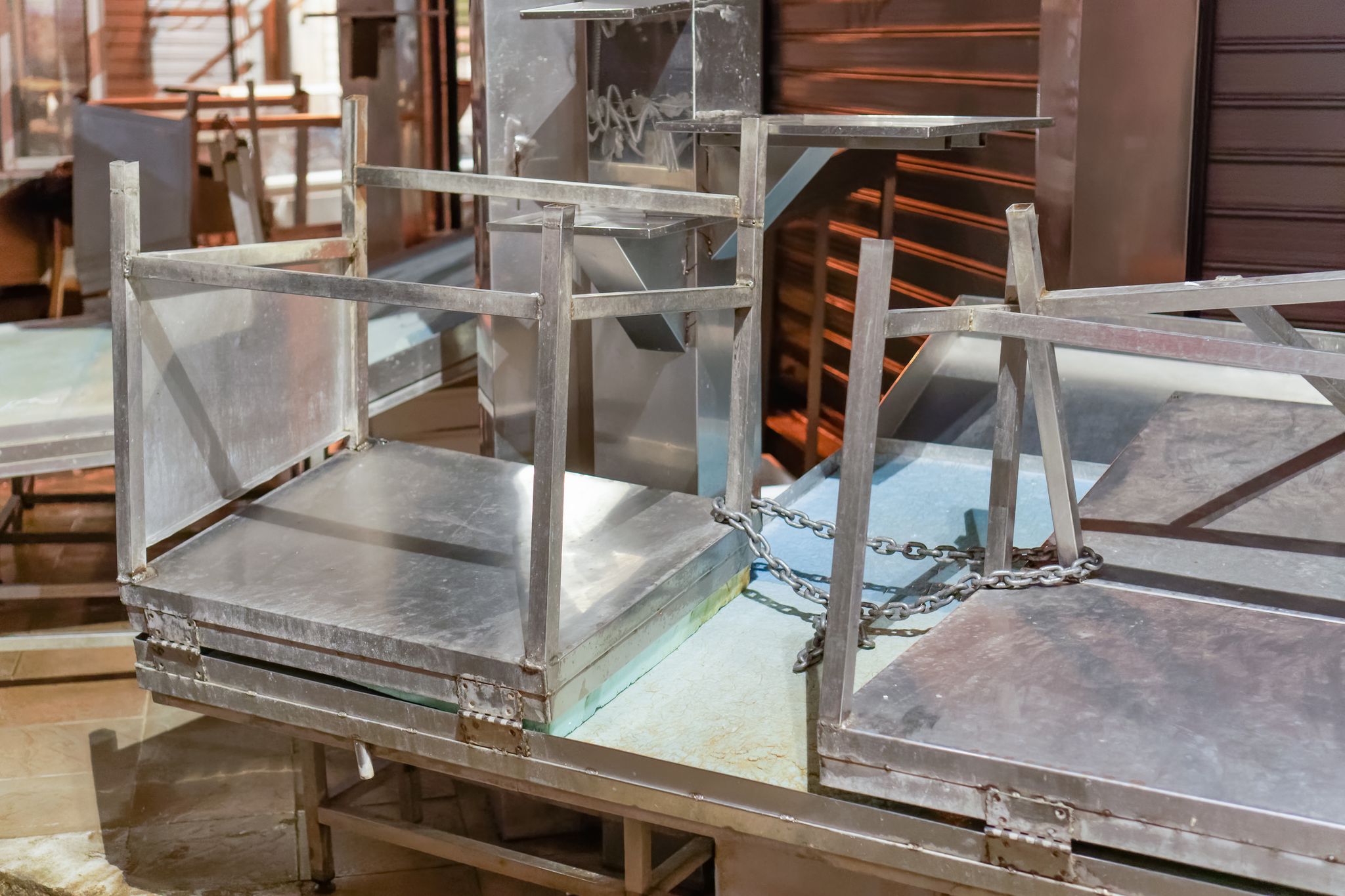 photo of Empty market food store stalls chained. Night view of indoors closed shops metal benches stacked at Kapani Market in Thessaloniki, Greece.,Thessaloniki  Greece.