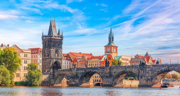 Photo of scenic aerial sunset on the architecture of the Old Town Pier and Charles Bridge over the Vltava River in Prague, Czech.