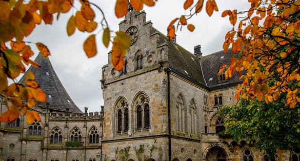 Bentheim Castle (Burg Bentheim), an early medieval hill castle in Bad Bentheim, Lower Saxony, Germany. Around castle a lot of autumn trees and green grass.