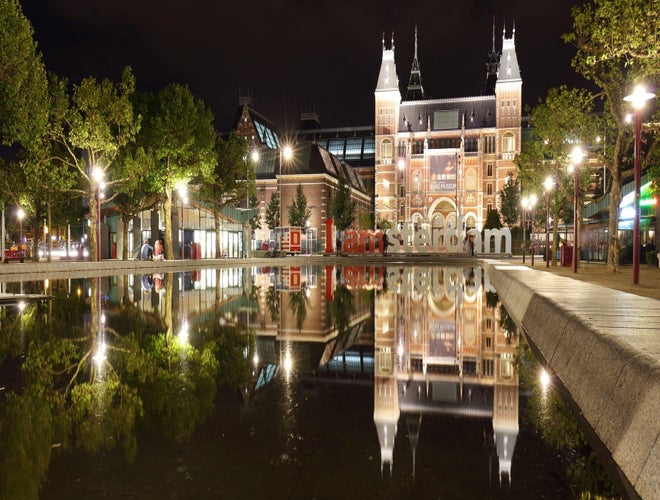 Night view of the Rijksmuseum and I amsterdam sign reflected in water at Museumplein..jpg