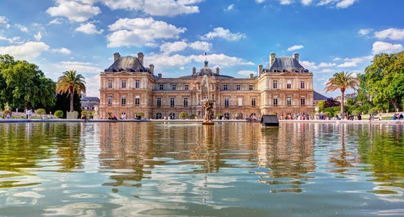 photo of The Luxembourg Palace in The Jardin du Luxembourg or Luxembourg Gardens in Paris, France. Luxembourg Palace was originally built (1615-1645) to be the royal residence of the regent Marie de Medici.