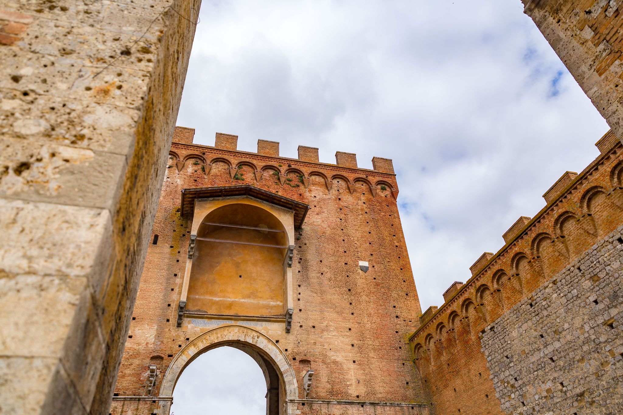 photo of view of Porta Romana is one of the portals in the medieval Walls of Siena. It is located on Via Cassia in Siena, region of Tuscany, Italy..