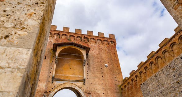 photo of view of Porta Romana is one of the portals in the medieval Walls of Siena. It is located on Via Cassia in Siena, region of Tuscany, Italy..