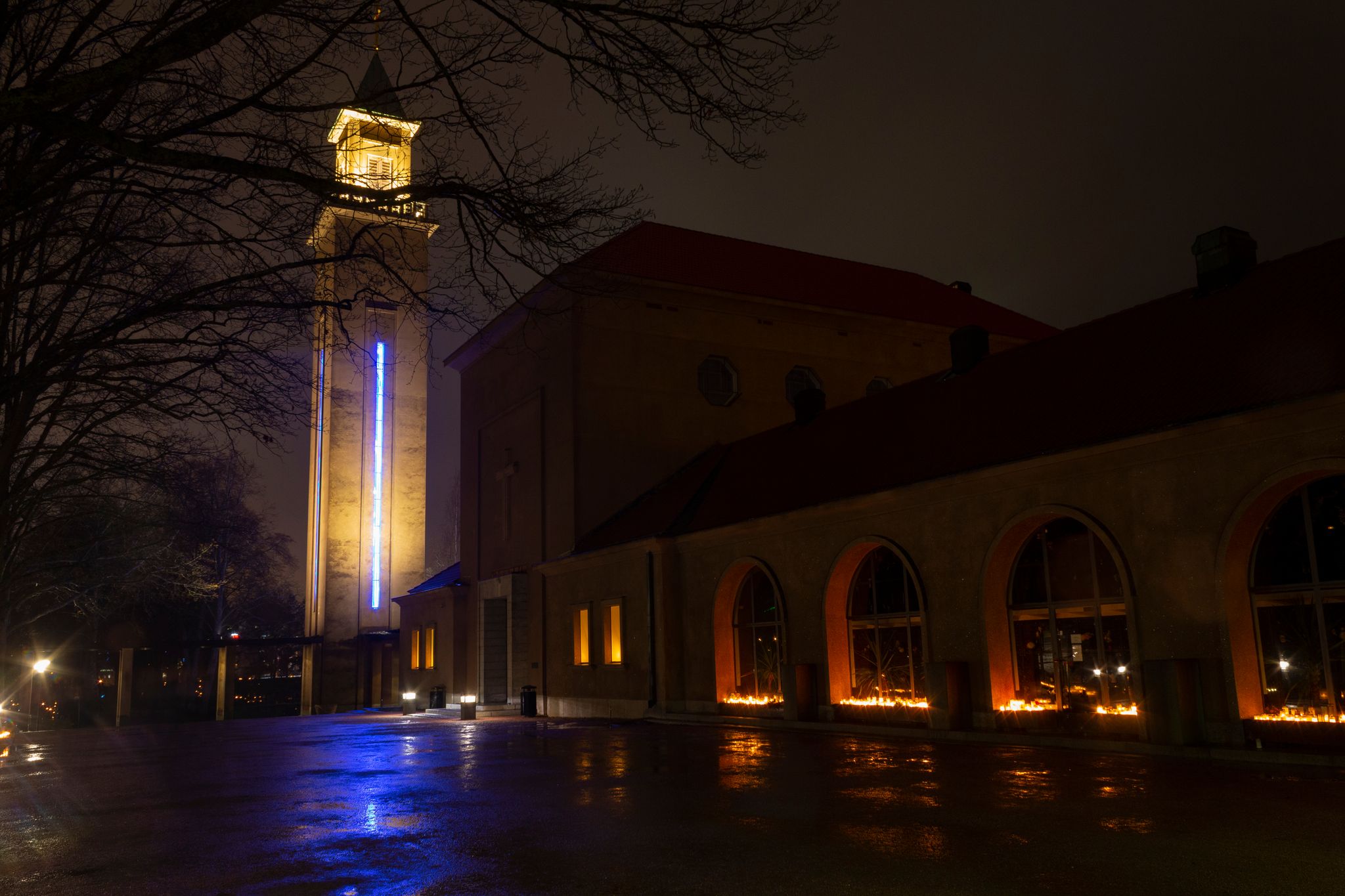 Photo of Chapel tower in the Hietaniemi cemetery in Helsinki with Christmas illumination and burning candles, Finland.