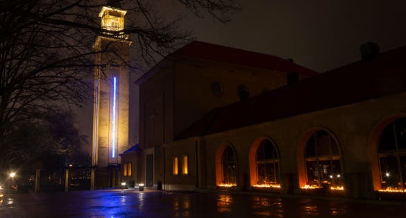 Photo of Chapel tower in the Hietaniemi cemetery in Helsinki with Christmas illumination and burning candles, Finland.
