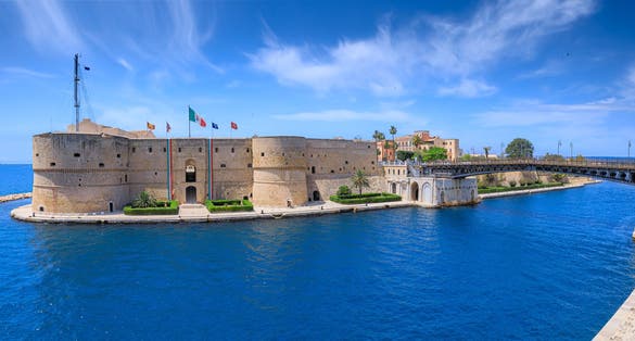 Taranto cityscape: iconic view with Aragonese Castle and Ponte Girevole (Swing Bridge) in Apulia, Italy.