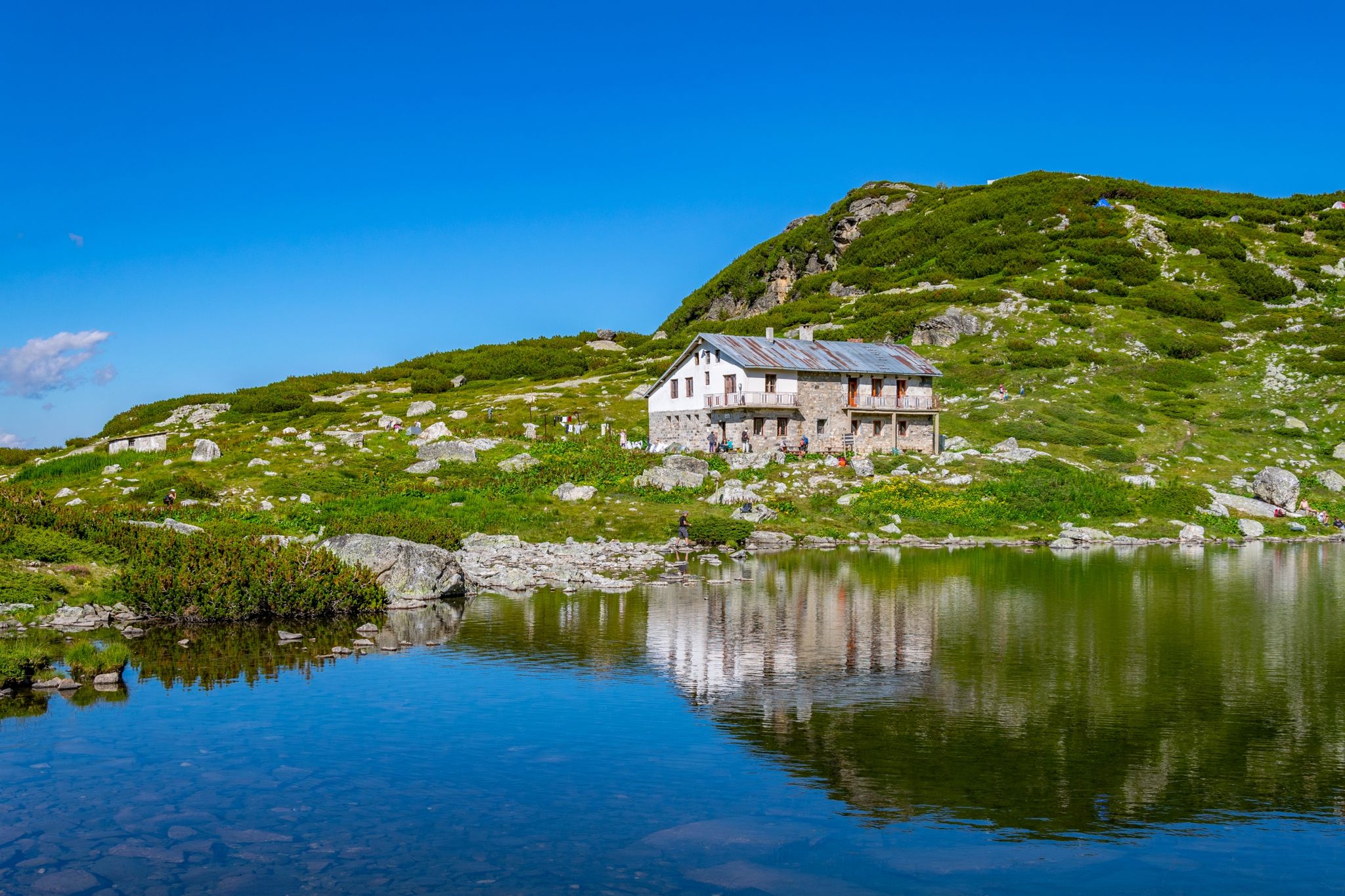 photo of view of Fish lake, one of the seven rila lakes in Bulgaria with Seven lakes hut,Kyustendil Bulgaria.