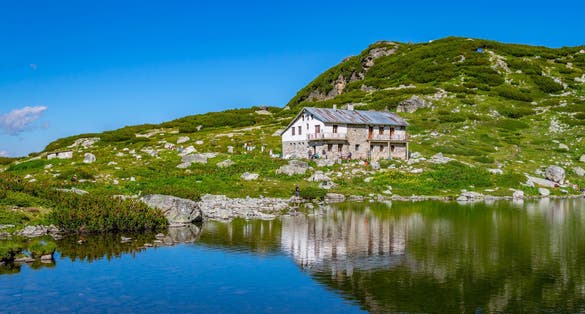 photo of view of Fish lake, one of the seven rila lakes in Bulgaria with Seven lakes hut,Kyustendil Bulgaria.
