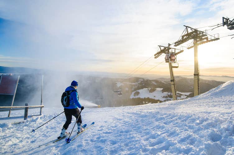 Male skier skiing on ski slope at Donovaly ski resort in Slovakia