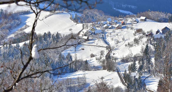 On the photo is winter landscape from Slovenia. With tipicaly village on the hill. View from Tolsti vrh, Celje.