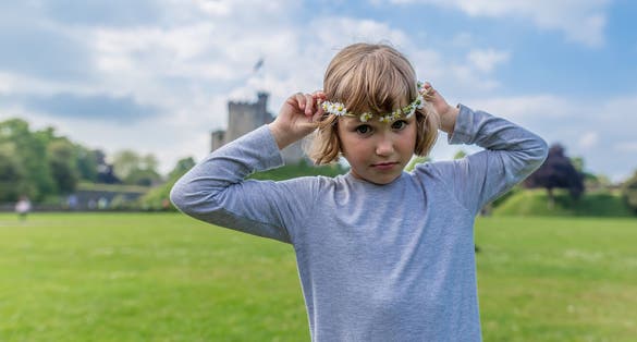 School girl with daisies in Cardiff castle, Wales