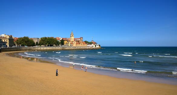 View of San Pedro church at San Lorenzo beach in Gijon, Asturias, Spain