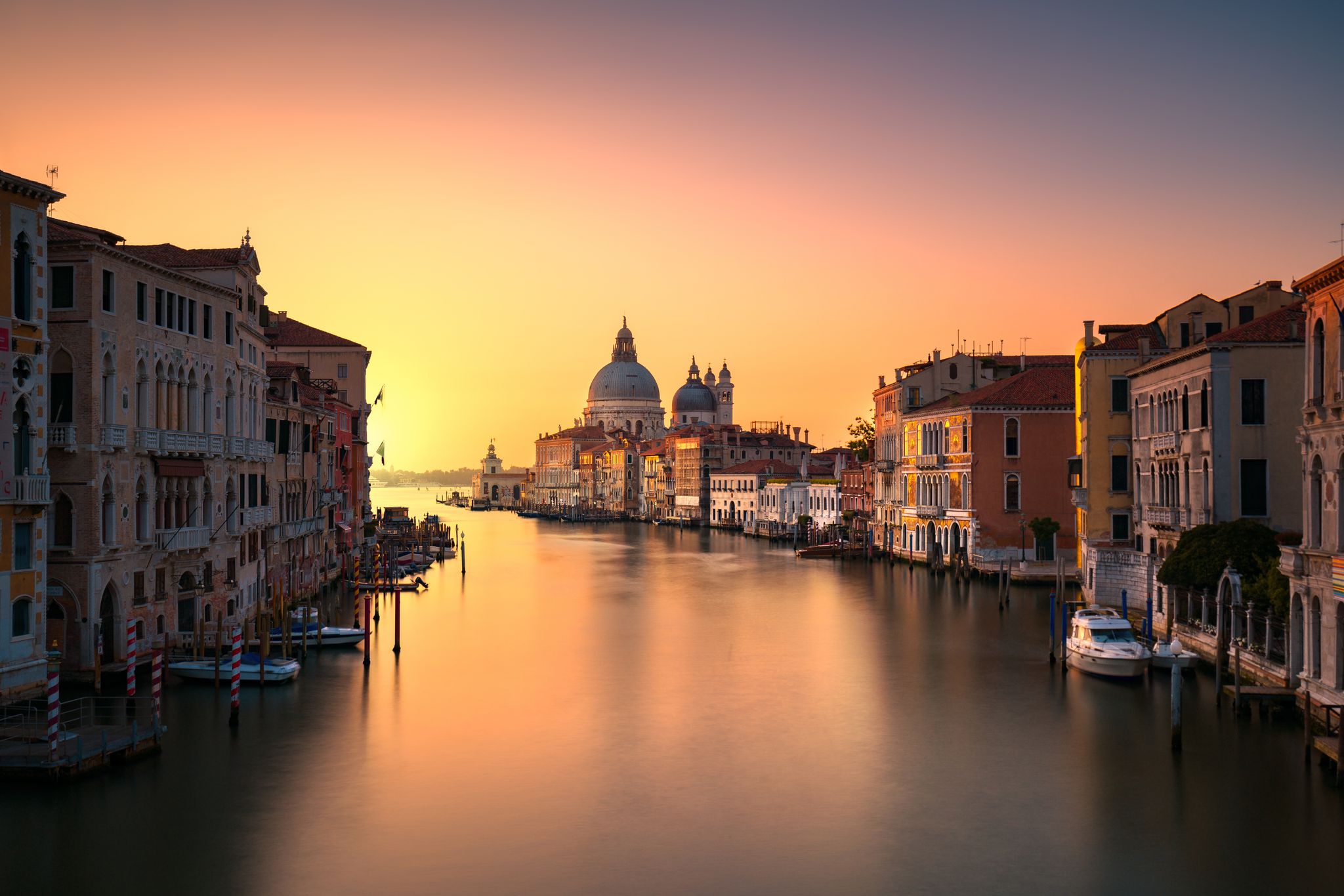 photo of Beautiful view of traditional Gondola on Canal Grande with Basilica di Santa Maria della Salute in the background on a sunny day in Venice, Italy .