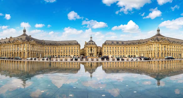 photo of the water mirror in front of the Place de la Bourse in Bordeaux in a beautiful summer morning in France.
