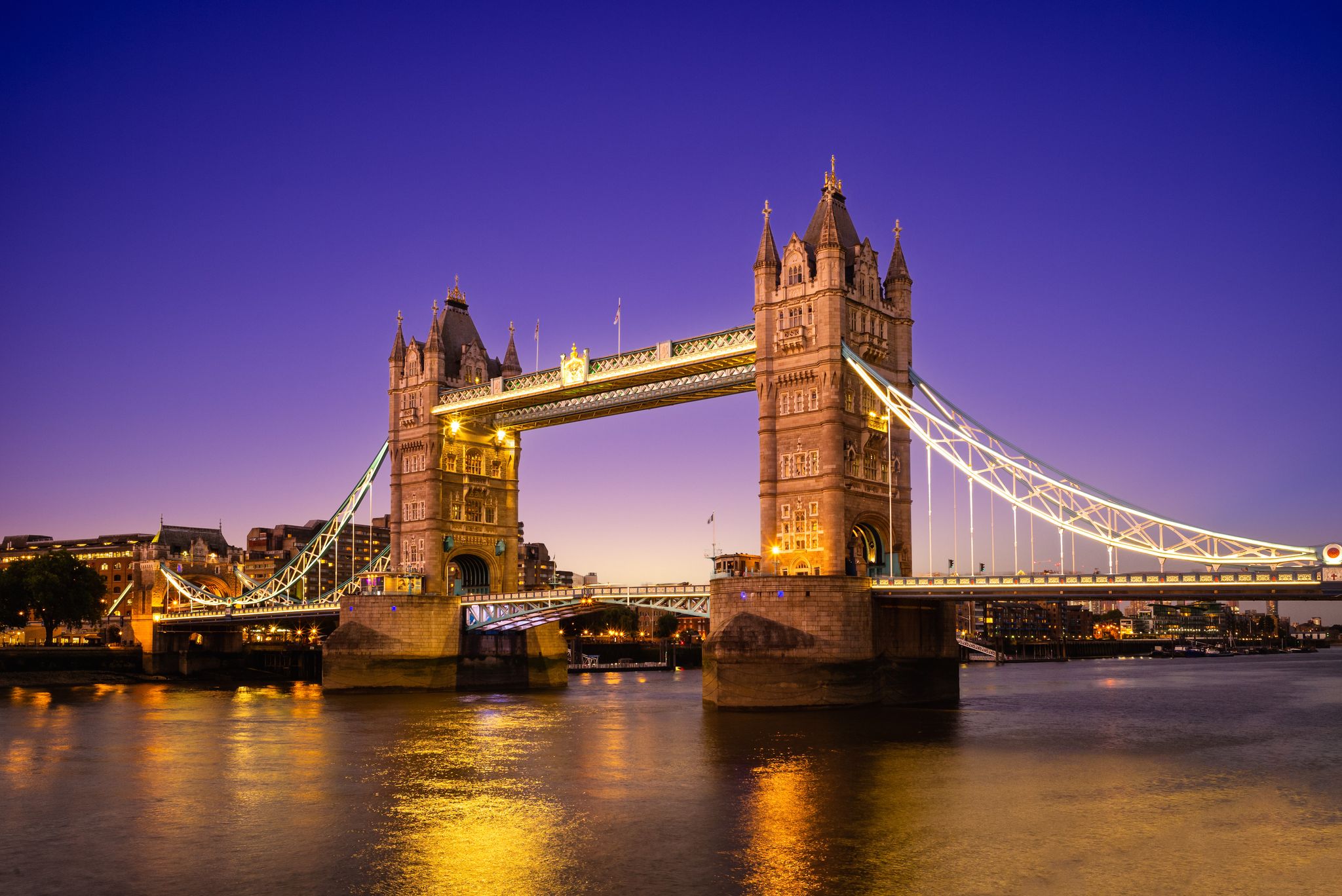 Photo of iconic Tower Bridge illuminated at night in London. One of London's most famous bridges and must-see landmarks on the Thames River.