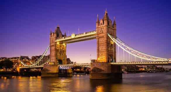 Photo of iconic Tower Bridge illuminated at night in London. One of London's most famous bridges and must-see landmarks on the Thames River.