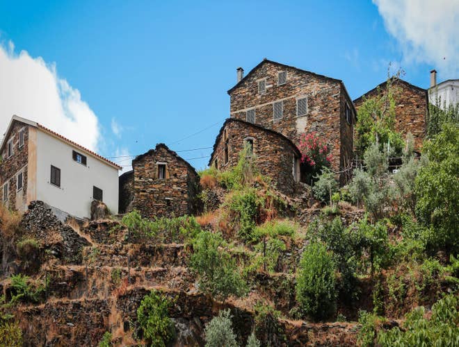 Stone houses in a traditional schist village surrounded by greenery, a hidden gem to explore in Portugal in August..jpg