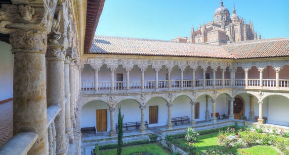 Photo of cloister of the convent of the owners with the cathedral in the background in Salamanca, Spain.