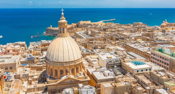 Photo of aerial view of Our Lady of Mount Carmel church, St.Paul's Cathedral and Manoel Island at sunrise, Valetta, Malta.