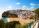 Photo of beautiful aerial view of the sandy beach surrounded by typical white houses in a sunny spring day, Carvoeiro, Lagoa, Algarve, Portugal.