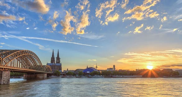 Photo of Cologne sunset city skyline with Cologne Cathedral and Rhine River, Cologne, Germany.