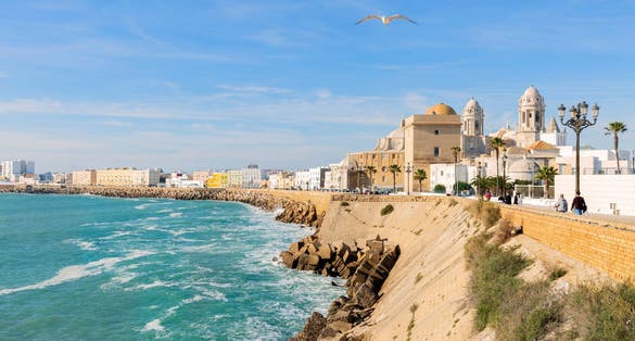 Beautiful view at day of the cathedral of Cadiz called cathedral de Santa Cruz with its 2 towers and its golden dome.