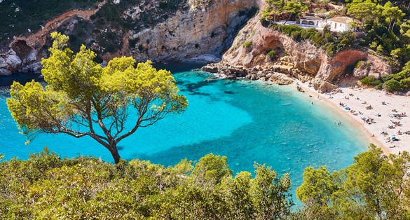 Photo of spanish mediterranean sunny scenic coastline. La Granadella beach. Alicante, Valencia.