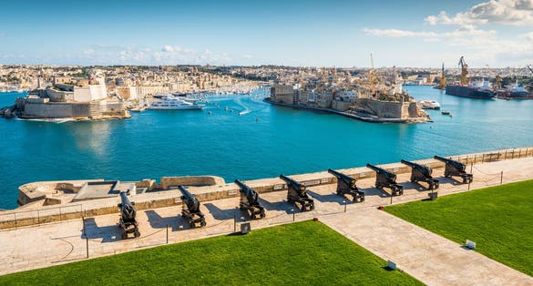 Photo of Cannons of the Saluting Battery point out over the Grand Harbour and Fort St Angelo, on a clear morning, Upper Barrakka Gardens, Capital city of Malta, Valletta, Malta.