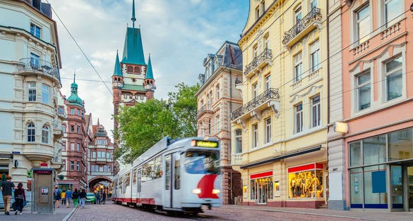 photo of Historic town of Freiburg im Breisgau with tram and famous medieval Martinstor (Martin's Gate) town gate in beautiful day in summer, state of Baden-Wurttemberg, Germany.