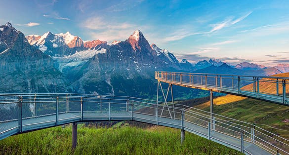 photo of morning panorama view in Grindelwald. Popular tourist attraction cliff walk at the first station. Swiss alps, Grindelwald valley, Switzerland.