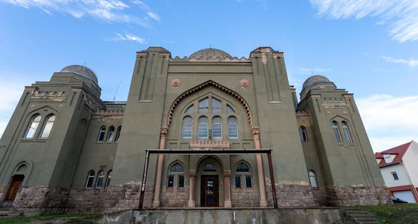 photo of view of Synagogue in Gyongyos, Hungary on a winter evening.