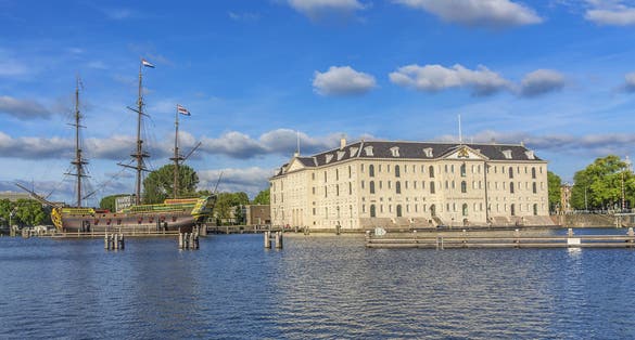 photo of a replica (1985) of ship Amsterdam was moored next to Netherlands Maritime Museum in Amsterdam, Netherlands. VOC ship Amsterdam was an 18th century cargo ship of Dutch East India company.