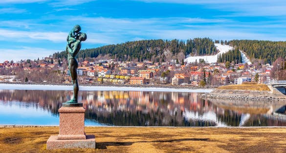 Skyline of Ostersund with a statue of father and a kid in Sweden.