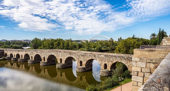 photo of view of Historical Bridge, built by the Romans. It is the longest surviving Roman bridge, over the Guadiana River in Merida, Extremadura, Spain. Puente Romano is the Spanish name for the Roman Bridge.